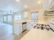 Well-lit kitchen featuring white cabinets, tile countertops, and stainless steel dishwasher at 172 Cloudcrest Dr, Henderson, NV 89015