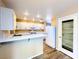 Bright kitchen features white cabinets, modern appliances, and a breakfast bar at 172 Cloudcrest Dr, Henderson, NV 89015