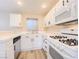 Updated kitchen with white cabinets, sleek appliances, and laminate flooring at 172 Cloudcrest Dr, Henderson, NV 89015