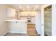 Updated kitchen with white cabinetry, bar, and stainless-steel appliances at 172 Cloudcrest Dr, Henderson, NV 89015
