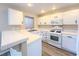 Well-appointed kitchen boasts white cabinetry, tile countertops, and gas range at 172 Cloudcrest Dr, Henderson, NV 89015