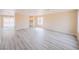 Open-concept living space featuring new gray-toned vinyl flooring and a view into the adjacent kitchen at 172 Cloudcrest Dr, Henderson, NV 89015