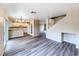 Open-concept living room with wood-look flooring, flowing into the kitchen area at 172 Cloudcrest Dr, Henderson, NV 89015