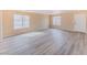 Spacious living room with new gray-toned vinyl flooring and two large windows offering natural light at 172 Cloudcrest Dr, Henderson, NV 89015