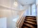 Well-lit staircase featuring carpeted steps and a modern pendant light fixture at 172 Cloudcrest Dr, Henderson, NV 89015