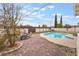 Private backyard with a sparkling pool, brick-paved patio, and lush landscaping creating a serene outdoor retreat at 212 N Torrey Pines Dr, Las Vegas, NV 89107