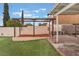 This backyard features a putting green, pergola and space to gather at 212 N Torrey Pines Dr, Las Vegas, NV 89107