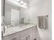 Bright bathroom featuring a large mirror, modern lighting, and a marble countertop sink at 212 N Torrey Pines Dr, Las Vegas, NV 89107