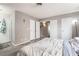 Bedroom featuring a queen bed, dark wood-look flooring, multiple closet doors, and neutral wall paint at 212 N Torrey Pines Dr, Las Vegas, NV 89107