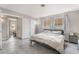 Bedroom featuring a queen bed, dark wood-look flooring, and view into the next room at 212 N Torrey Pines Dr, Las Vegas, NV 89107