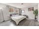 Bedroom featuring a queen bed, dark wood-look flooring, and neutral wall paint at 212 N Torrey Pines Dr, Las Vegas, NV 89107