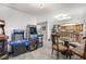 Dining area with a glass table, chairs and view of an assortment of arcade machines and kitchen at 212 N Torrey Pines Dr, Las Vegas, NV 89107