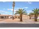 Charming single-story home boasting mature palm trees, a two-car garage, and inviting curb appeal for comfortable living at 212 N Torrey Pines Dr, Las Vegas, NV 89107