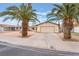 Charming single-story home with a well-manicured yard and mature palm trees at 212 N Torrey Pines Dr, Las Vegas, NV 89107
