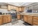 Kitchen featuring stainless steel oven, microwave, dishwasher and wooden cabinets and ample countertop space at 212 N Torrey Pines Dr, Las Vegas, NV 89107