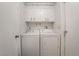 Functional laundry room featuring a side-by-side washer and dryer, and ample cabinet storage for household essentials at 212 N Torrey Pines Dr, Las Vegas, NV 89107