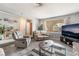 Inviting living room featuring a comfortable sofa, recliner, large windows and contemporary decor at 212 N Torrey Pines Dr, Las Vegas, NV 89107