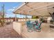 This outdoor patio features an outdoor dining set for entertaining and covered patio for shade at 212 N Torrey Pines Dr, Las Vegas, NV 89107