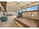 This large covered patio with television offers ample room for outdoor dining and relaxing near the pool at 212 N Torrey Pines Dr, Las Vegas, NV 89107