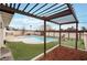 A beautiful backyard featuring a pool, putting green and outdoor kitchen space for entertaining at 212 N Torrey Pines Dr, Las Vegas, NV 89107