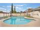 Inviting backyard pool with basketball hoop and rock waterfall feature for Gathering fun and outdoor relaxation at 212 N Torrey Pines Dr, Las Vegas, NV 89107