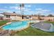 Backyard pool with lush grass, palm trees, and a trampoline. Perfect for summer fun at 212 N Torrey Pines Dr, Las Vegas, NV 89107