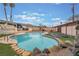 This backyard pool is surrounded by rocks and grass for a private outdoor space to relax and enjoy at 212 N Torrey Pines Dr, Las Vegas, NV 89107