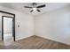 Bright bedroom features a modern ceiling fan, neutral paint, and wood-look flooring at 2120 Maple Springs St, Henderson, NV 89002