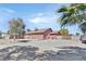 Wide view of a large backyard featuring mature trees, privacy wall, and spacious area at 2221 Mohawk St, Las Vegas, NV 89146