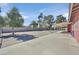 Large backyard featuring a covered patio, block wall, and mature trees at 2221 Mohawk St, Las Vegas, NV 89146