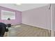 Spacious bedroom with ample natural light from the large window and hardwood floors at 2221 Mohawk St, Las Vegas, NV 89146
