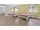 Bright bedroom with two beds, wood floors, and mirror closet doors at 2221 Mohawk St, Las Vegas, NV 89146