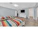 Bedroom with two beds, wood floors, television, and mirror closet doors at 2221 Mohawk St, Las Vegas, NV 89146
