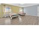 Bedroom with two beds, wood floors, two windows, and neutral walls at 2221 Mohawk St, Las Vegas, NV 89146