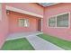 Inviting front entrance with lush artificial turf, a tiled landing, and a warm, welcoming aesthetic at 2221 Mohawk St, Las Vegas, NV 89146