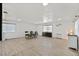 Spacious living room featuring modern wood floors, a large window, and a dining area at 2221 Mohawk St, Las Vegas, NV 89146