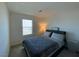 Bright bedroom with a neutral colored wall, a window, and minimalist decor at 2775 Atomic Tangerine Way # 4, Las Vegas, NV 89183