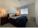 Cozy bedroom with carpet, a window letting in natural light, and matching nightstands at 2775 Atomic Tangerine Way # 4, Las Vegas, NV 89183