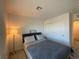 Bright bedroom with a neutral colored wall, closet with sliding doors, and minimalist decor at 2775 Atomic Tangerine Way # 4, Las Vegas, NV 89183