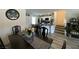 Open dining room with a long dark wood table and views to the kitchen at 2775 Atomic Tangerine Way # 4, Las Vegas, NV 89183