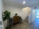 Inviting entryway with wood-look floors, a charming cabinet, two chairs, and staircase leading to the upper level at 2775 Atomic Tangerine Way # 4, Las Vegas, NV 89183