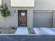Townhome exterior displaying a private garage, well-maintained landscaping, and a welcoming front entrance at 2775 Atomic Tangerine Way # 4, Las Vegas, NV 89183