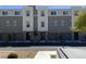 Modern townhome exteriors feature neutral paint, individual garages, and well-maintained landscaping at 2775 Atomic Tangerine Way # 4, Las Vegas, NV 89183