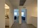 Hallway with view to bathroom and bedrooms featuring neutral carpeting at 2775 Atomic Tangerine Way # 4, Las Vegas, NV 89183