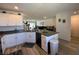 Bright kitchen featuring white cabinets, a peninsula counter, and stainless steel sink at 2775 Atomic Tangerine Way # 4, Las Vegas, NV 89183