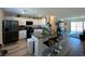 Modern kitchen with white cabinets, stainless steel appliances, and a center island with bar seating at 2775 Atomic Tangerine Way # 4, Las Vegas, NV 89183