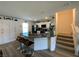 Bright kitchen with white cabinetry, stainless appliances, bar seating, and easy access to stairs at 2775 Atomic Tangerine Way # 4, Las Vegas, NV 89183