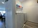 Convenient laundry room with modern washer and dryer, and shelving for storage at 2775 Atomic Tangerine Way # 4, Las Vegas, NV 89183