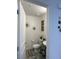 A tidy powder room features a white toilet and sink, along with decorative wall accents for a touch of style at 2775 Atomic Tangerine Way # 4, Las Vegas, NV 89183