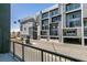 Modern condo building featuring balconies, a gray exterior, and decorative string lights at 2775 W Pebble Rd # 328, Las Vegas, NV 89123